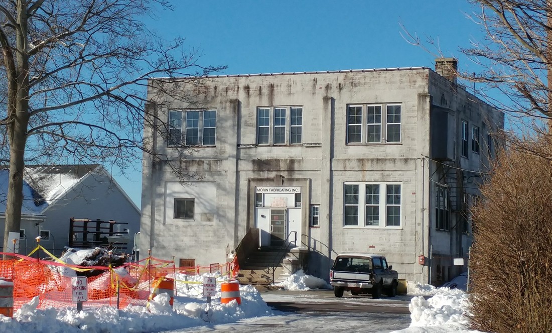 Old warehouse with construction surrounding it