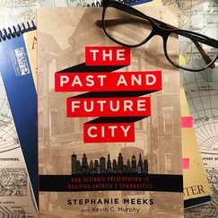 Photo of the book "The Past and Future City" with glasses and notebook