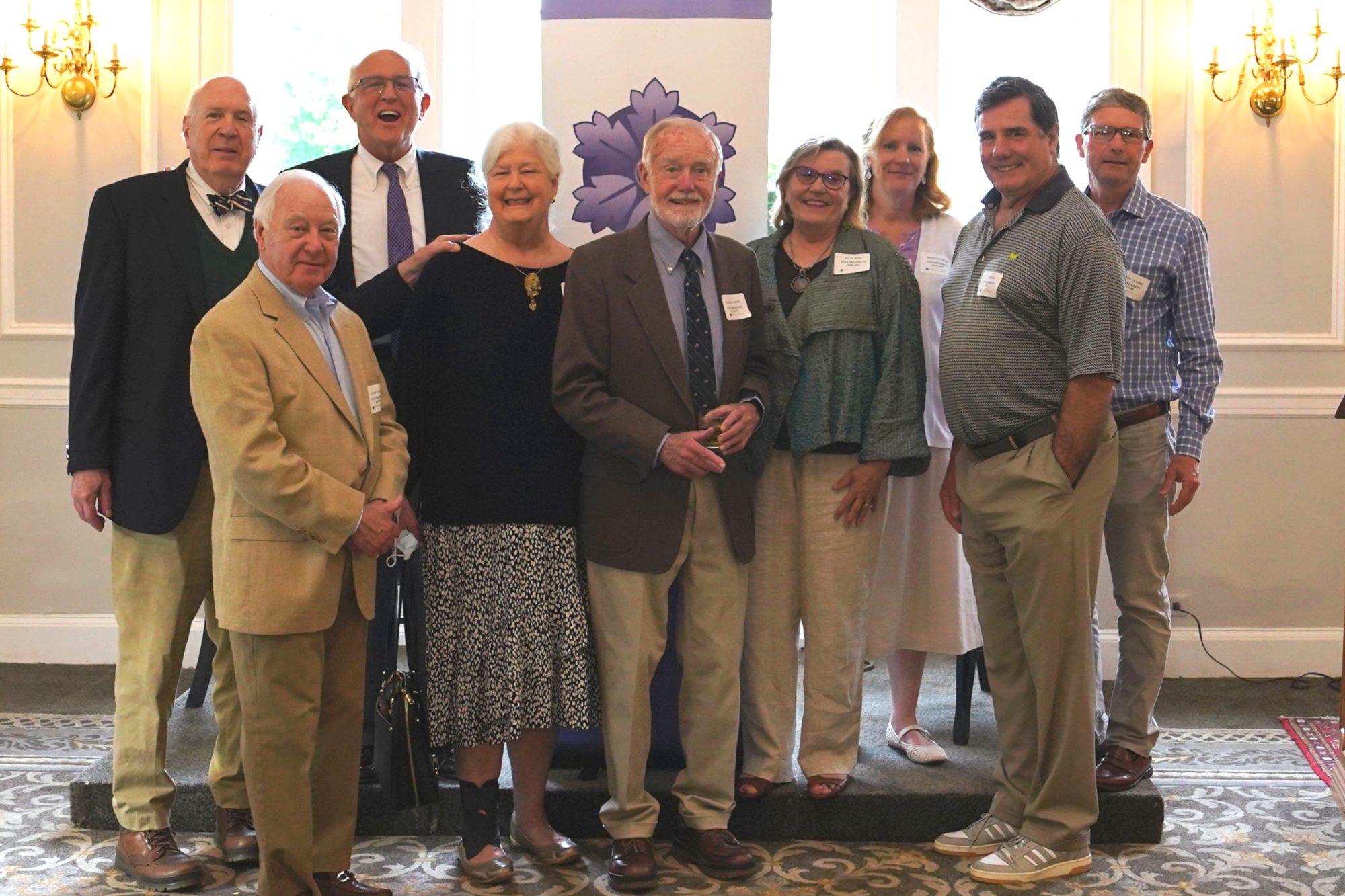 A group of individuals, former board memebrs of HSI, stand together