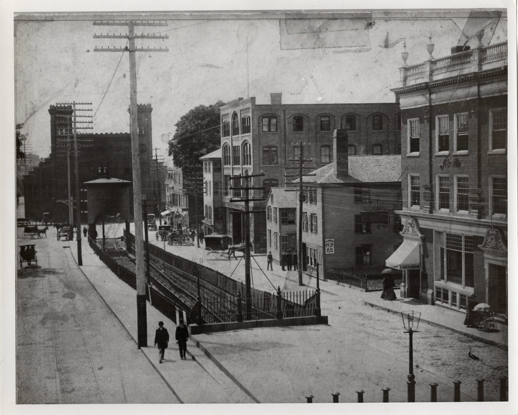 Historic black and white photo of Washington Street showing the 19th-century train station demolished in the 1950s.