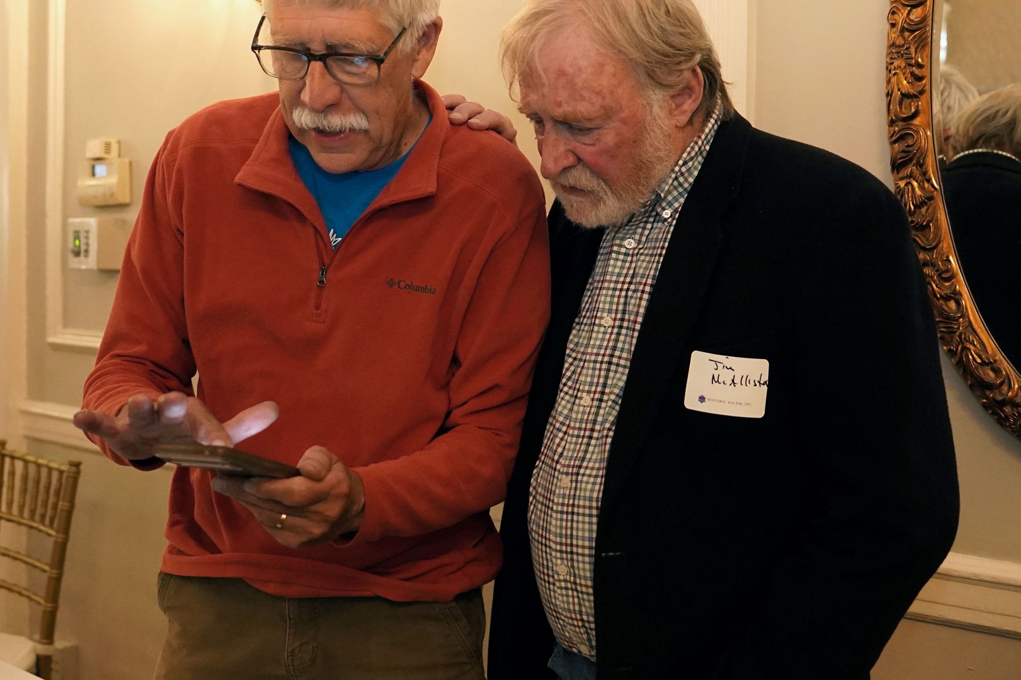 Two men stand togeher